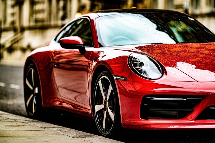 A photo of a clean red Porsche which has been cleaned with a TDS spot free washing system