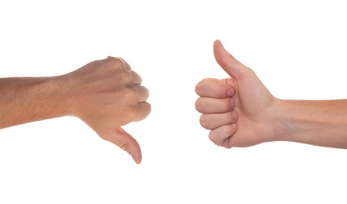 An image of a two hands making a thumbs up and thumbs down motion, symbolising pros and cons