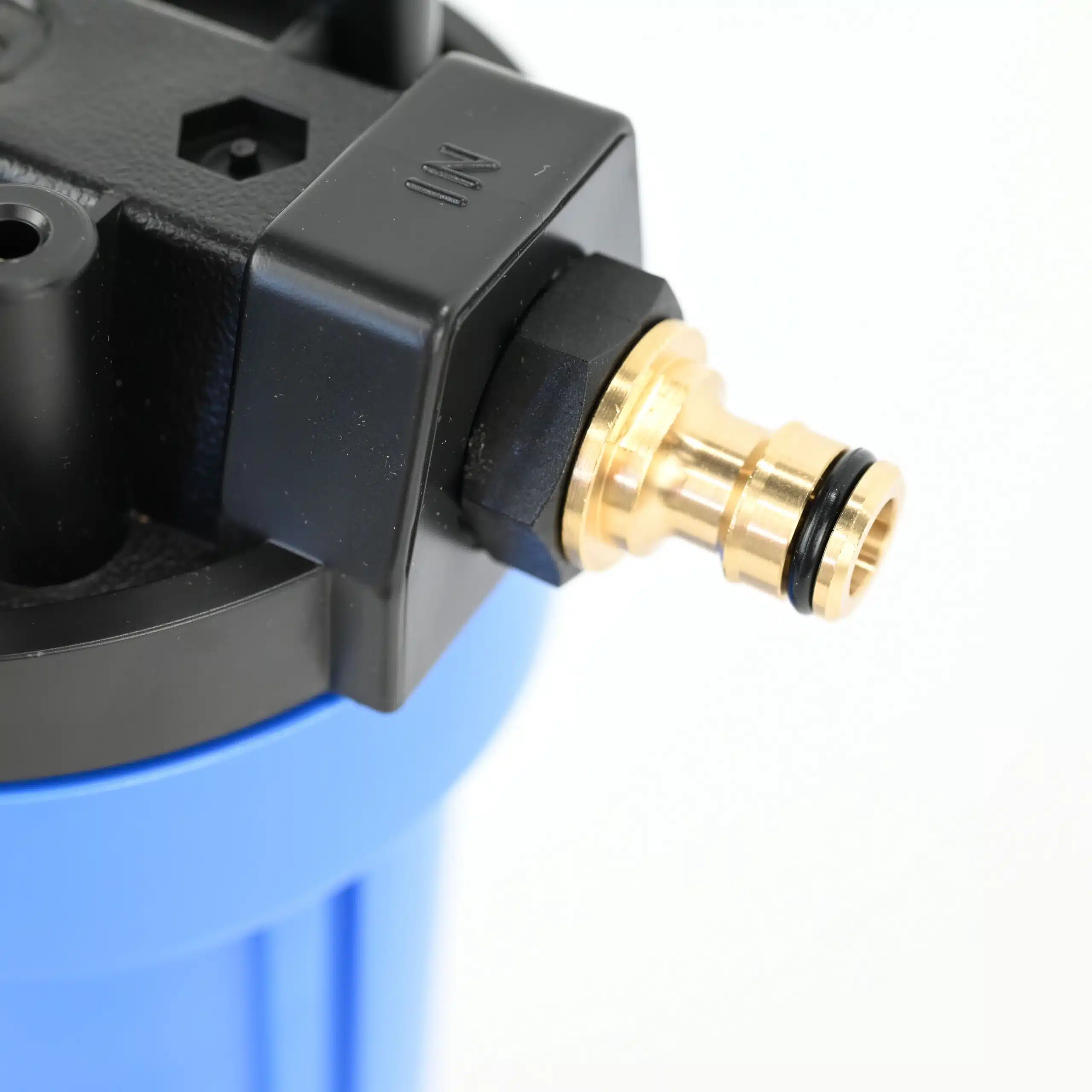 Close up photo of a brass push on hose fitting on the single 10 inch water filter system for caravans and rvs